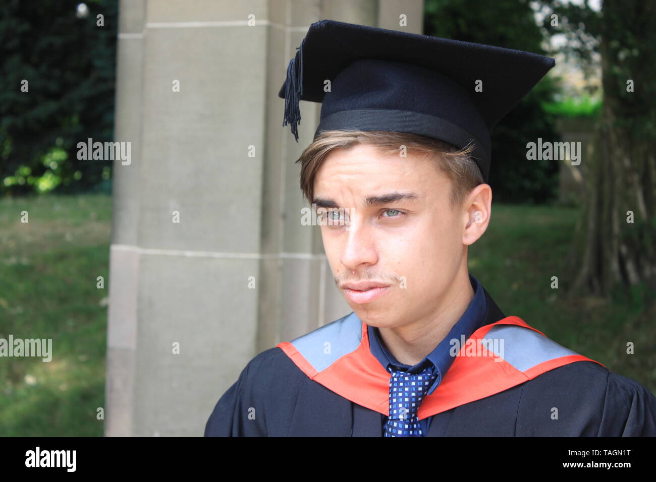 Young male Staffordshire University graduate at Trentham Gardens, Stoke-on-Trent on his graduation day Stock Photo
