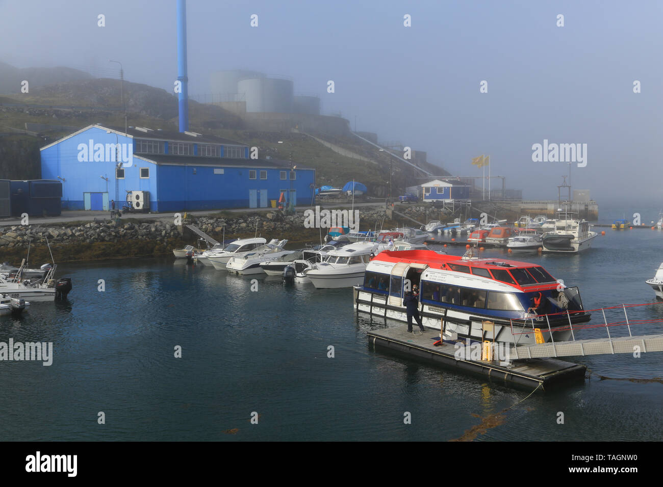 Marina and port facilities at Paamiut Village on the west coast of Greenland. Tendering boats operating from a visiting cruise ship. Stock Photo