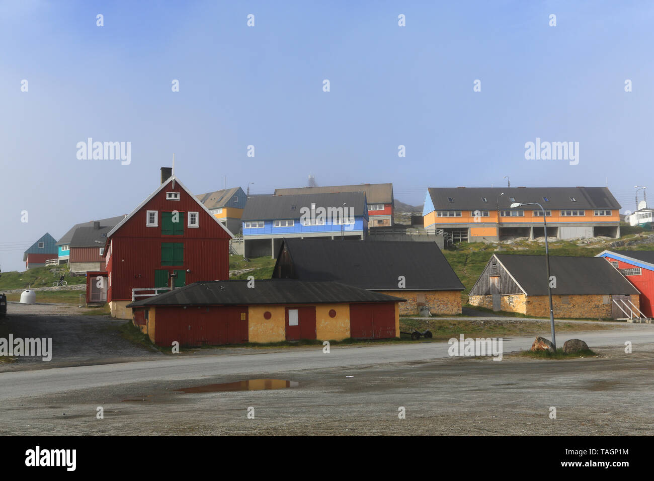 Buildings near the marina in the village of Paamiut on the west coast of Greenland. Yellow stone buildings are historic (over 100 years old). Stock Photo