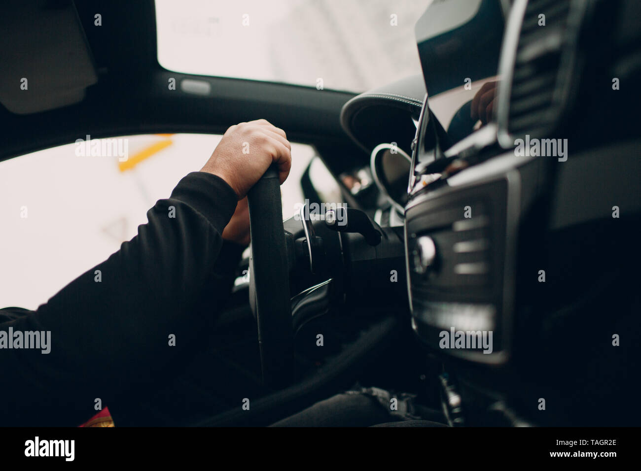 Driver hands behind the wheel Stock Photo - Alamy