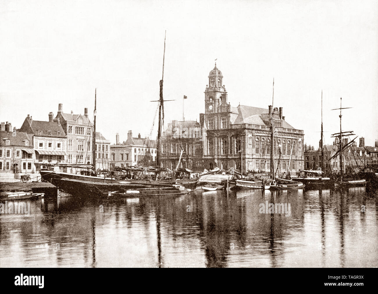 A late 19th Century view of the harbour and Town Hall built in the 1880s and a classic example of fine Victorian Gothic architecture in Great Yarmouth, aka Yarmouth, a seaside town in Norfolk, England. It has been a seaside resort since 1760 and rose to prominence when a railway built in 1844 gave visitors easier and cheaper access and triggered an influx of settlers. Stock Photo