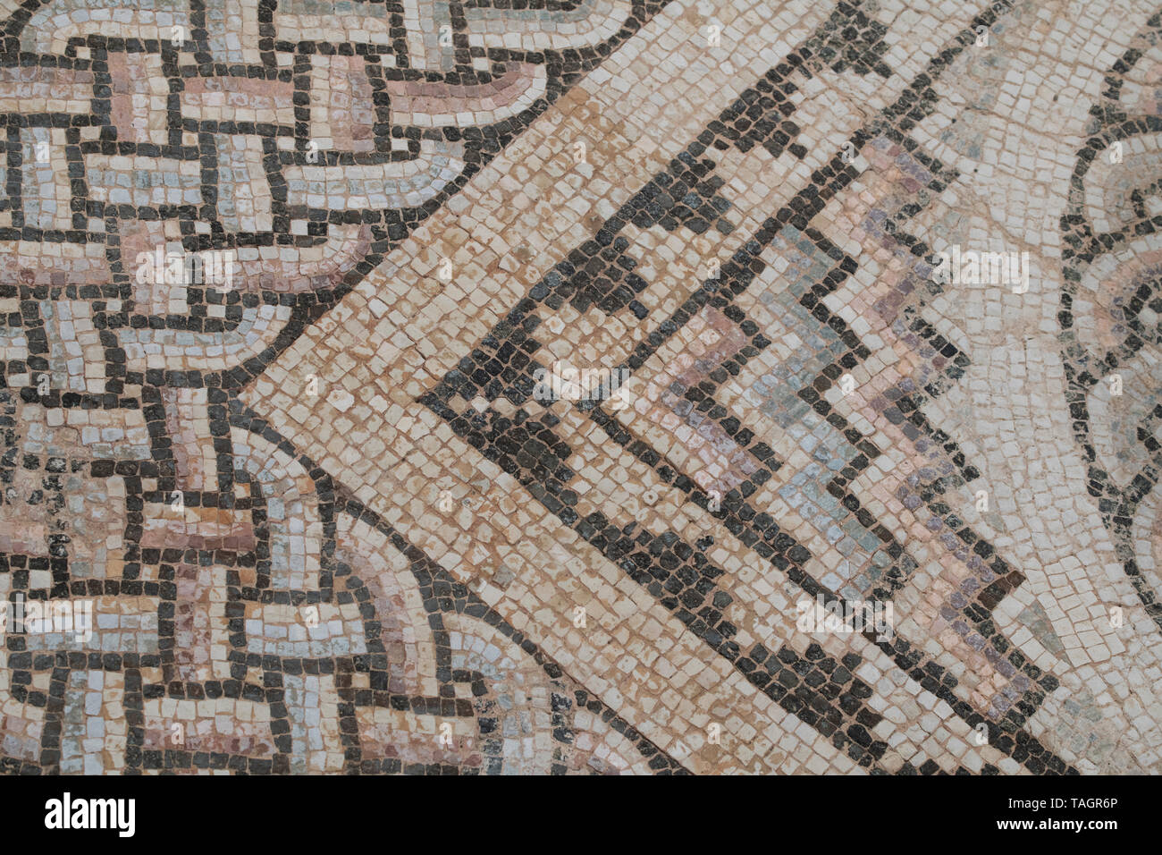 Cyprus, ancient archaeological site of Kourion. Detail of ancient Roman mosaic floor with ornate geometric design. Stock Photo