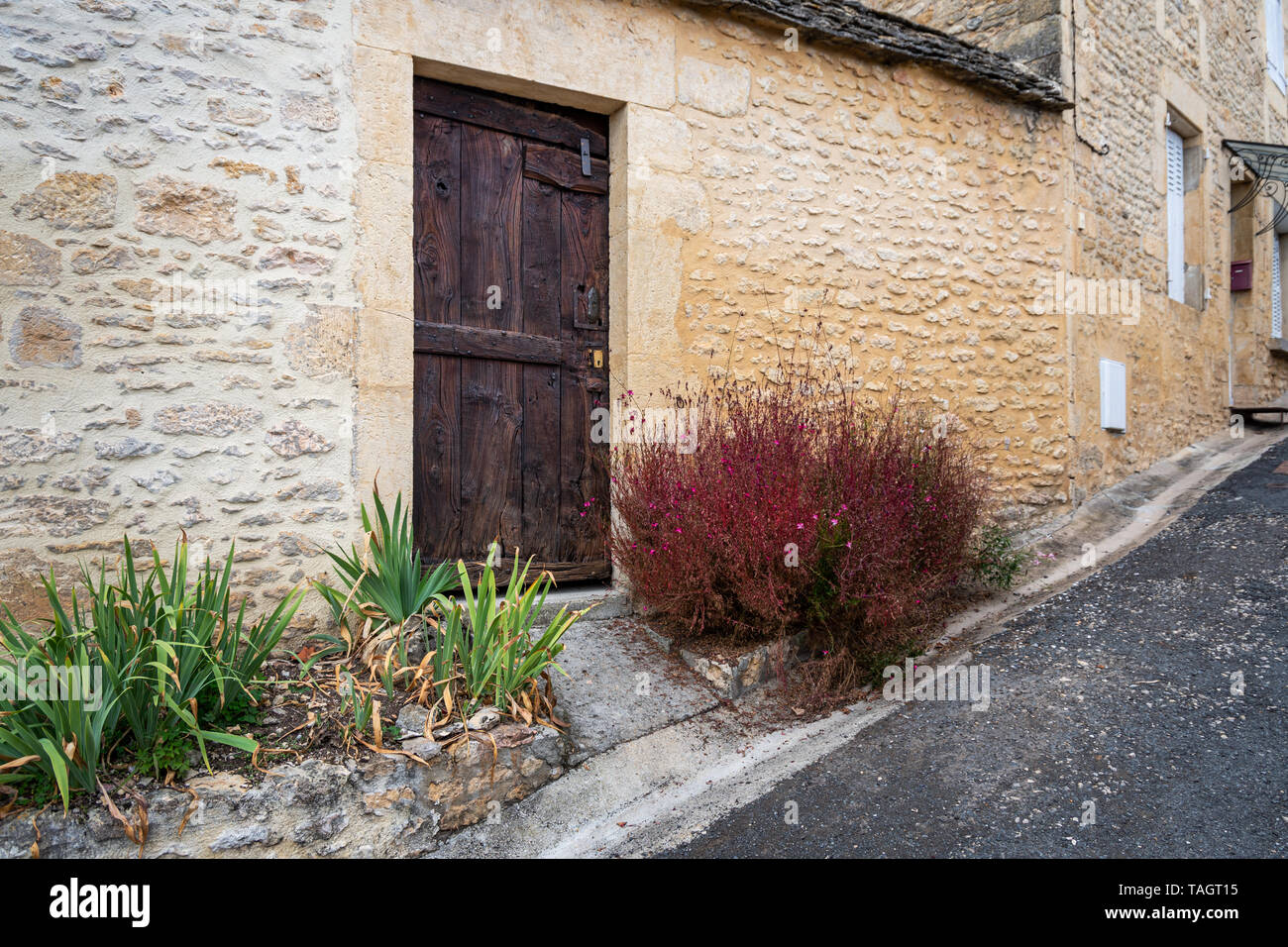 Rustic brown wooden door of an old stone house Stock Photo - Alamy