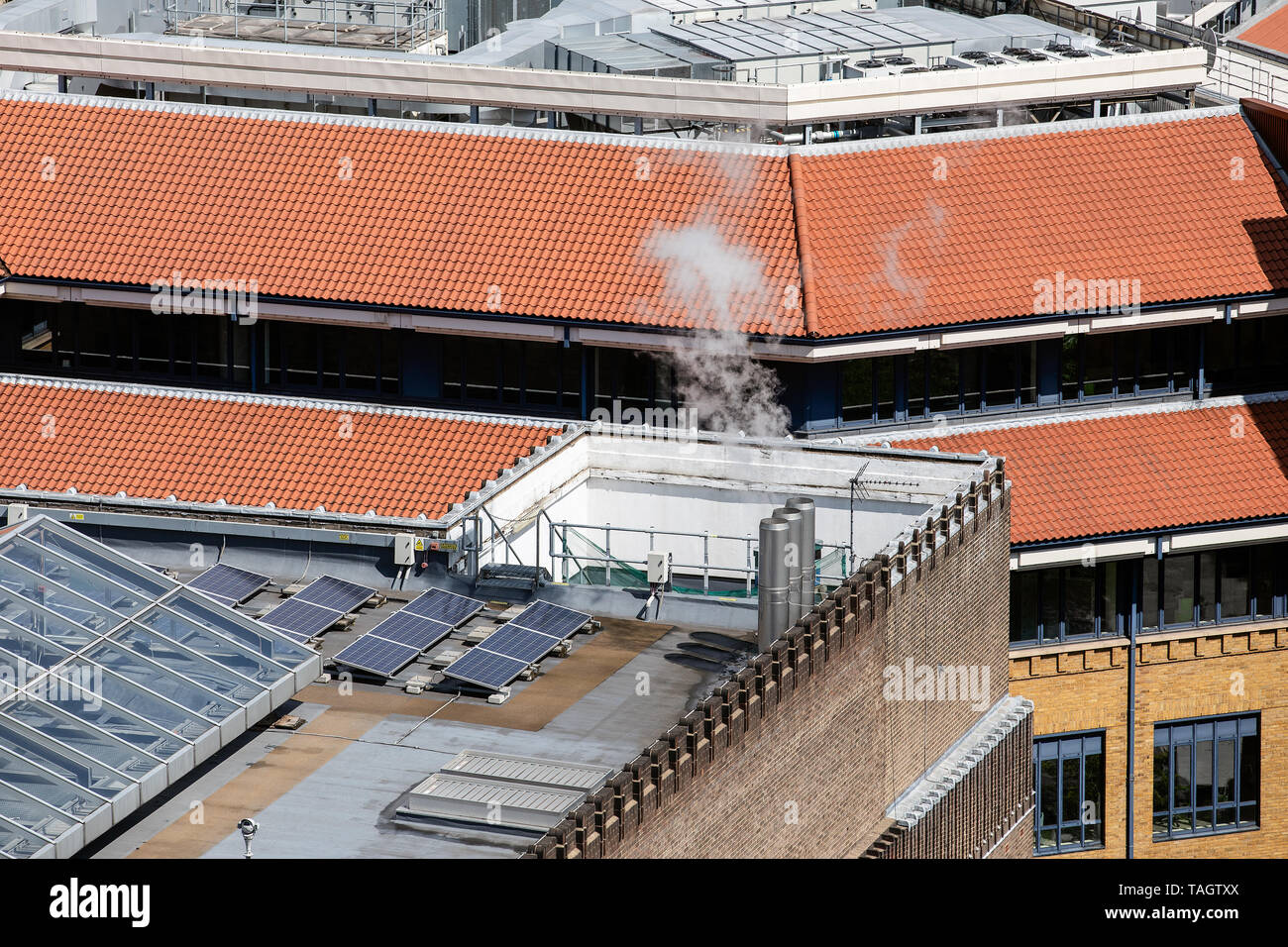 Solar panels on the roof. Gas heating chimneys and conditioning ...