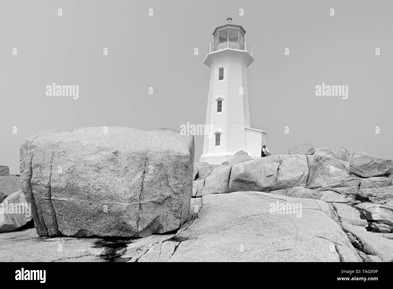 Lighthouse and rocky shoreline  Peggy's Cove Nova Scotia Canada Stock Photo