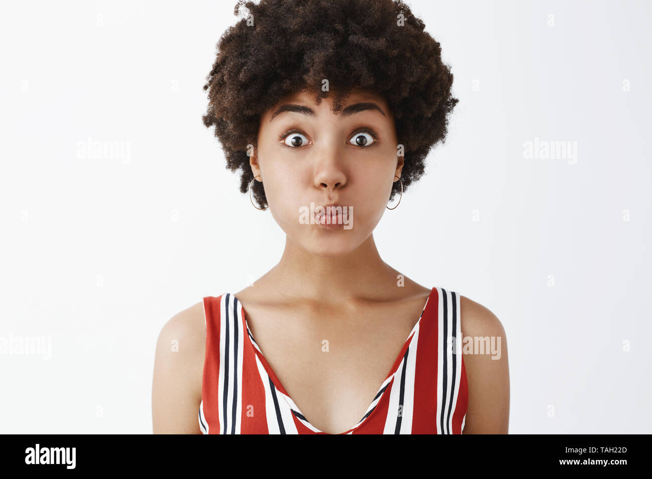 I am dumb like fish no secret will slip away. Portrait of playful and funny good-looking young african american with curly hair pouting, holding Stock Photo