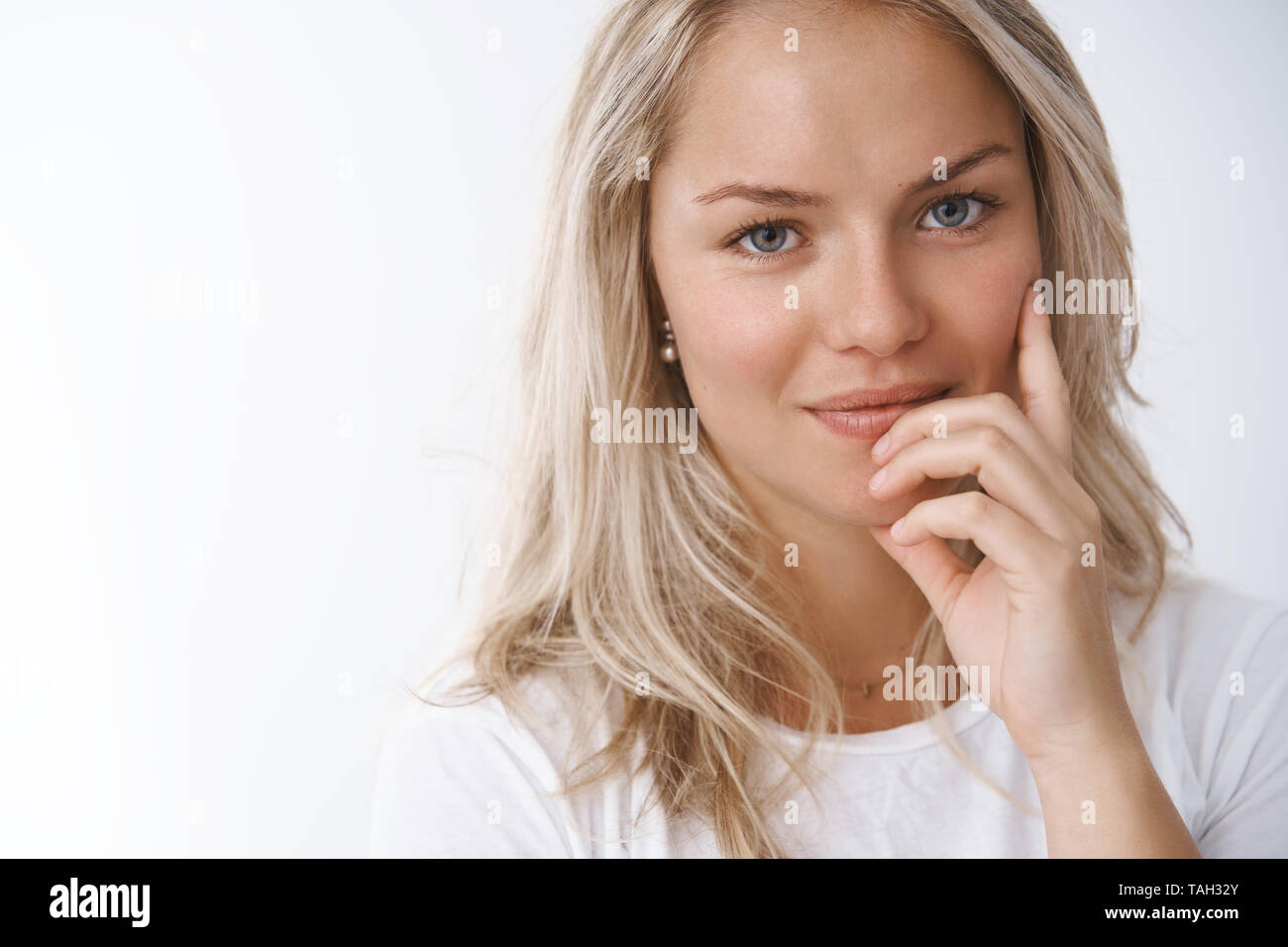 Headshot of tender and sensual attractive european blonde in white t ...