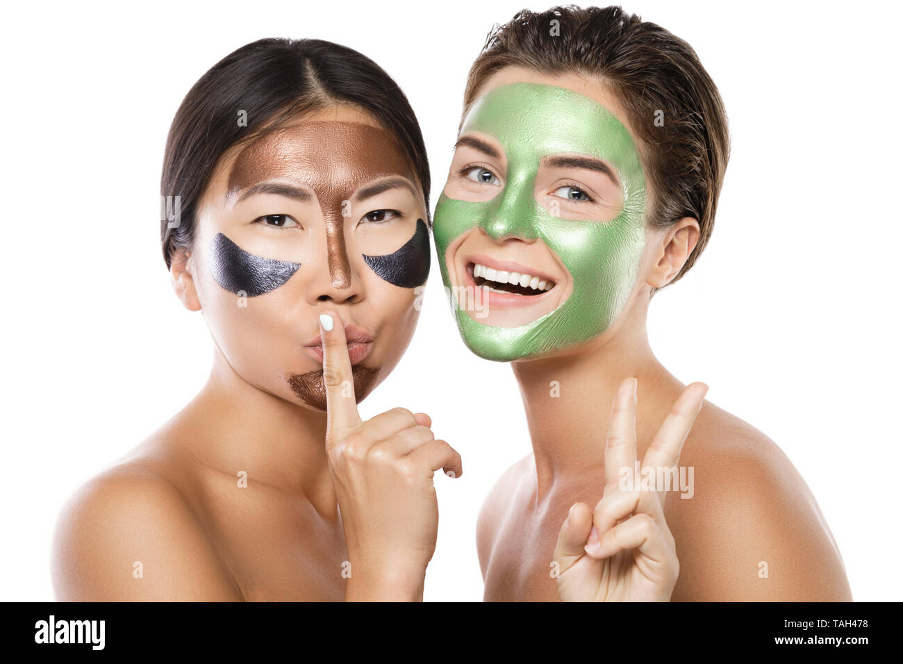 Two Beautiful Girls With Colorful Peel Off Masks On Their Faces