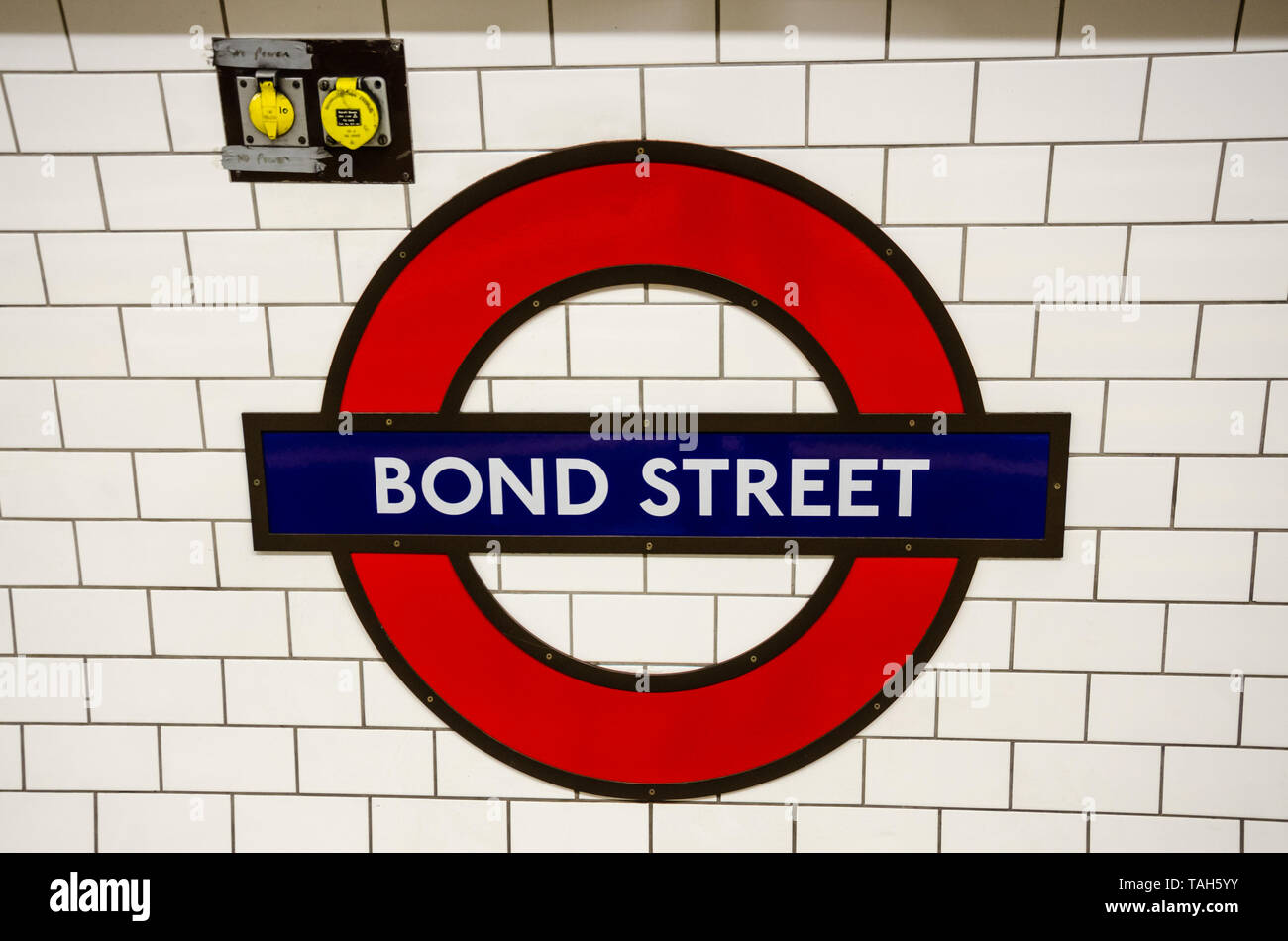 A London Underground emblem on the wall at Bond Street London Underground station. Stock Photo