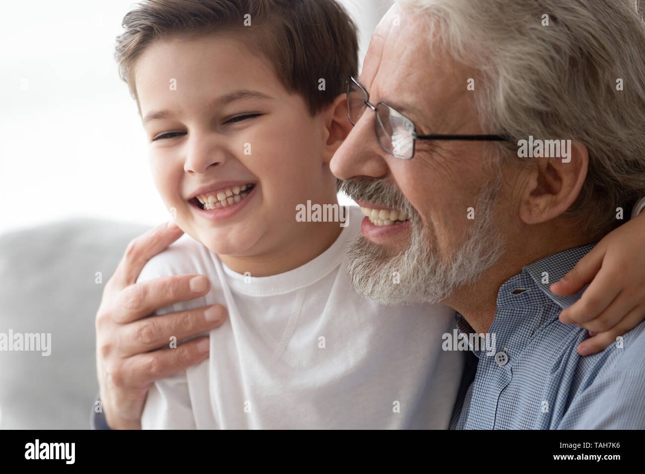 Close up of happy grandparent hug having fun with grandchild Stock Photo