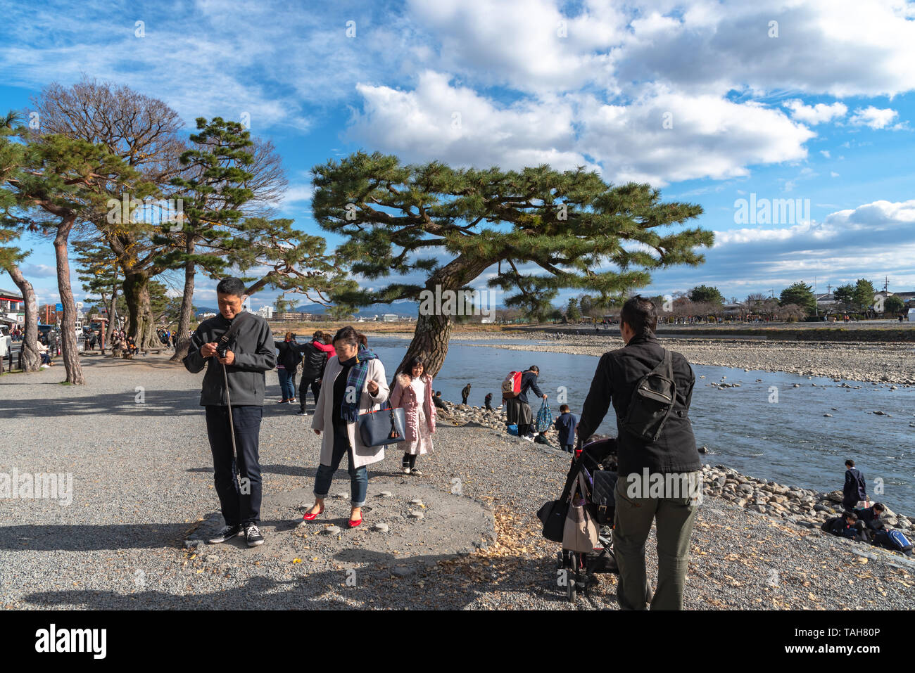 Aera of Togetsu-kyo bridge at Arashiyama district. Many local traditional souvenir shops and crowded tourists in the main street. Kyoto, Japan Stock Photo