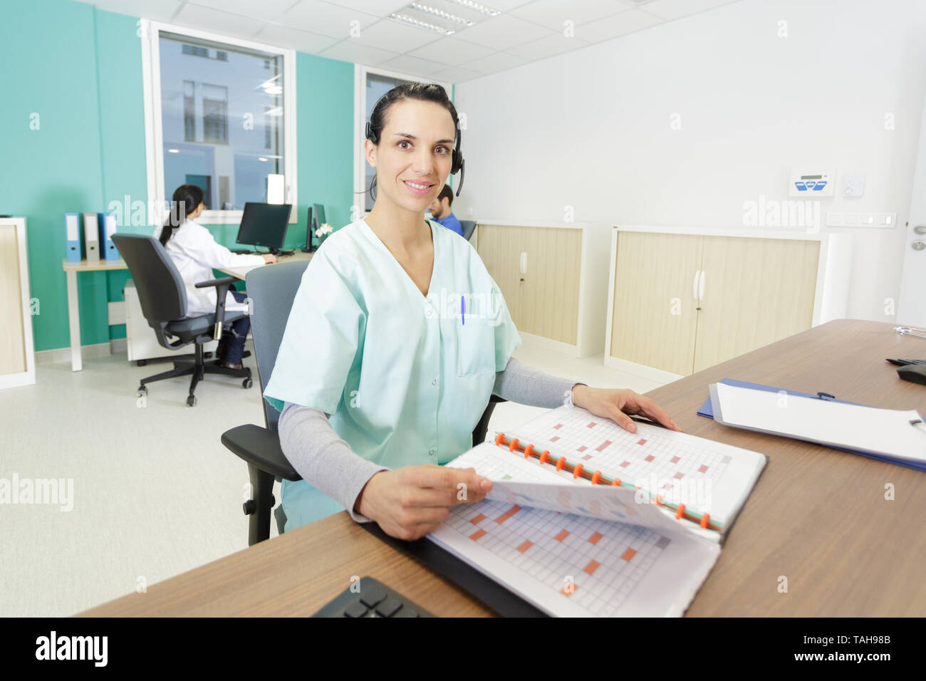 nurse receptionist on duty talking on phone Stock Photo Alamy