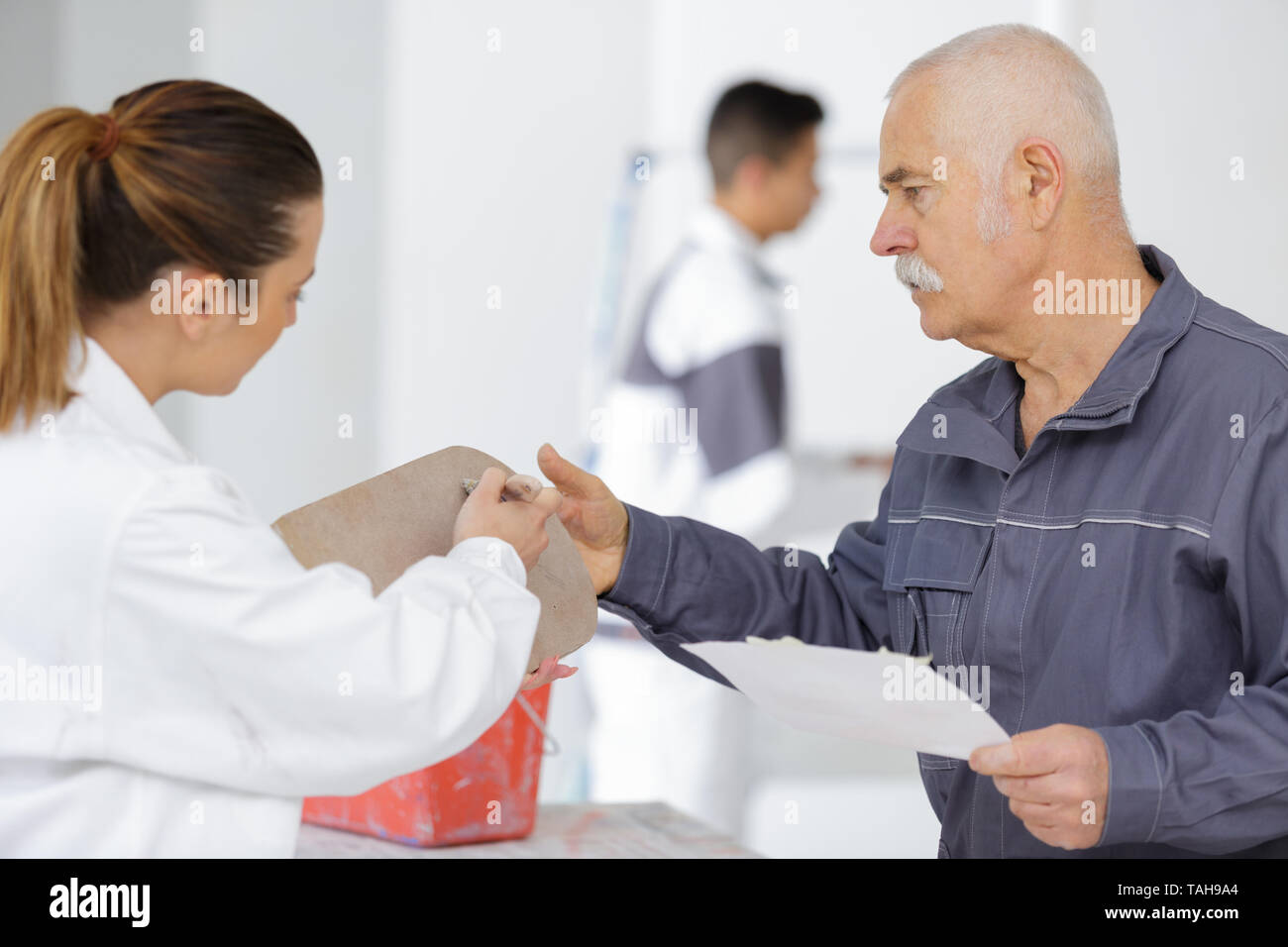 female and male painter working together Stock Photo