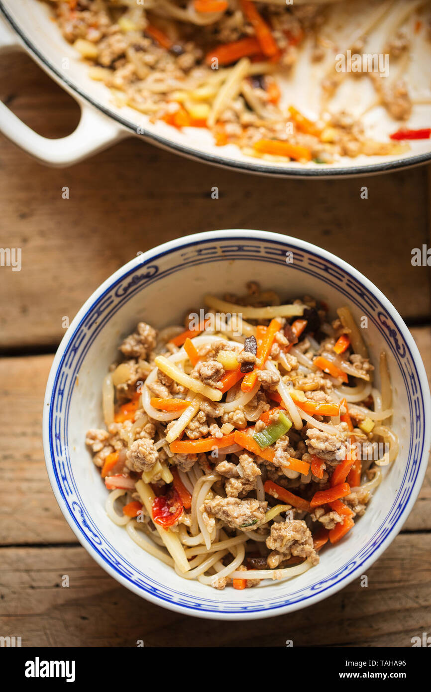 Chinese pork noodle stir fry with egg noodles and vegetables Stock