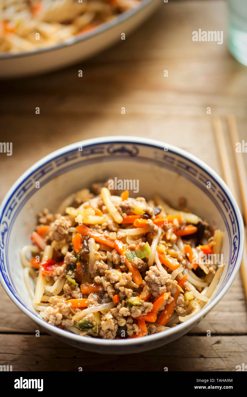 Chinese pork noodle stir fry with egg noodles and vegetables Stock