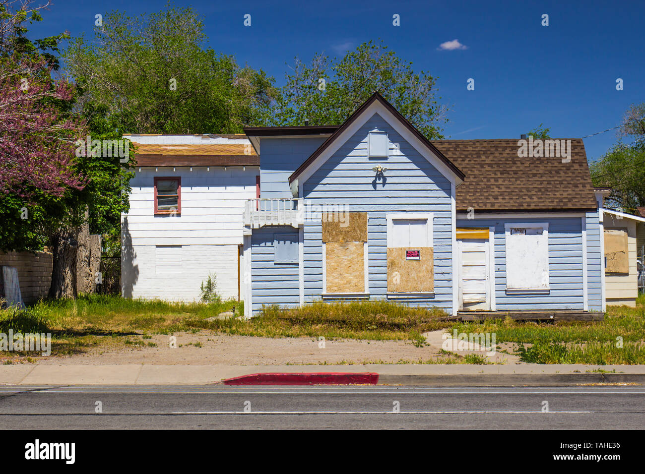 Abandoned Boarded Up Home Lost In Foreclosure Stock Photo