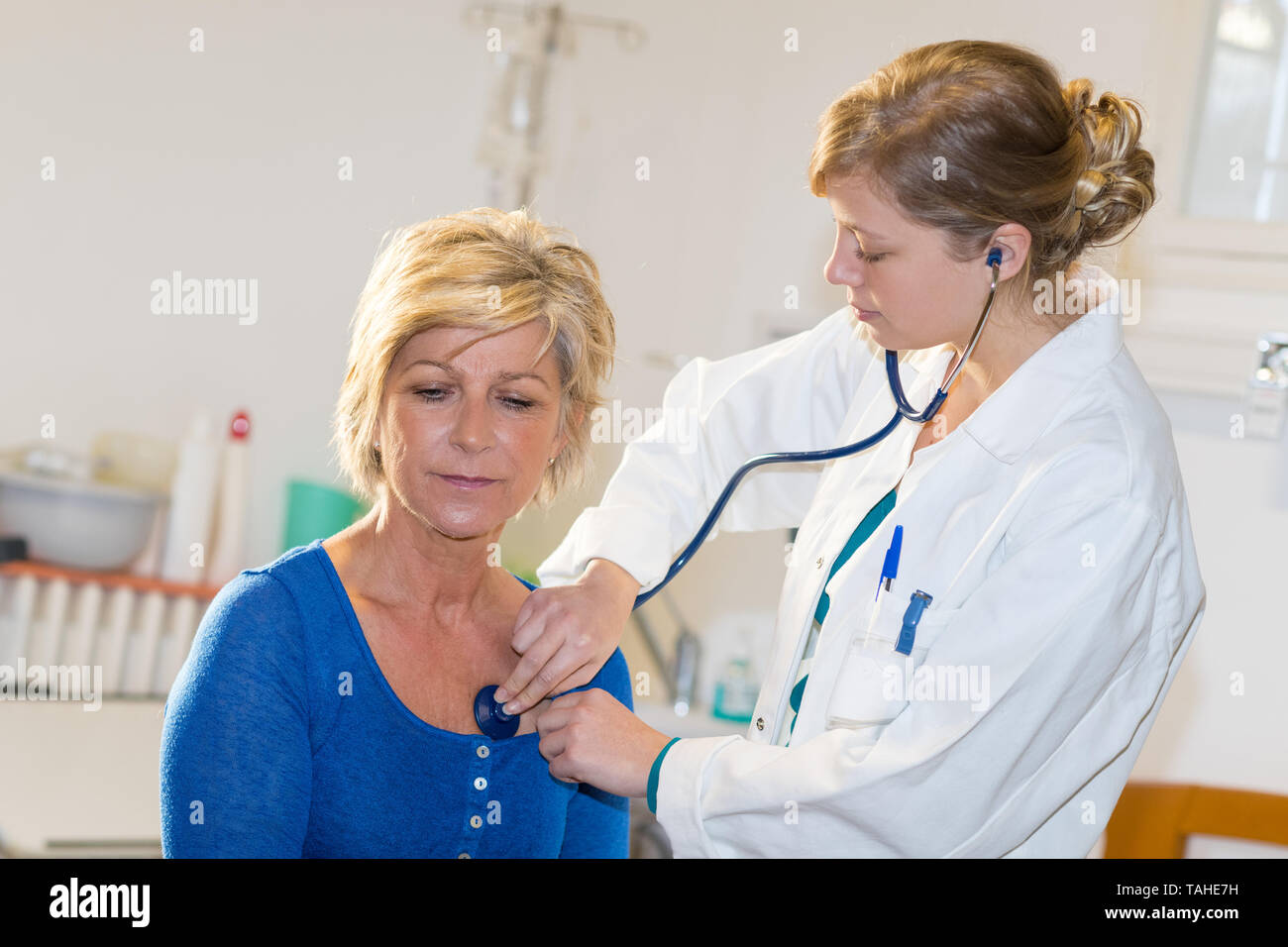 nurse is counting heart rate of a female patient Stock Photo Alamy