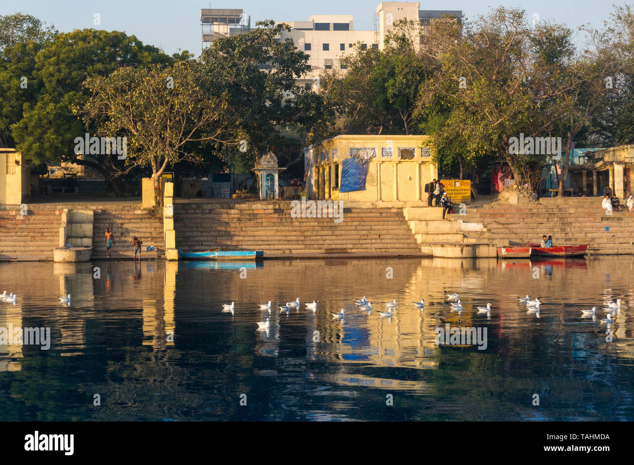 Delhi, India - circa 2019: Yellow temples and hindu buildings on the yamuna ghat bank in Delhi. This ghat near kashmiri gate is a popular tourist plac Stock Photo