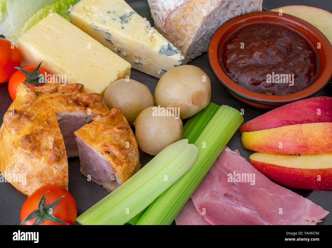 Ploughman's Lunch, a cold meal of bread, cheese, meat and onions. Stock Photo