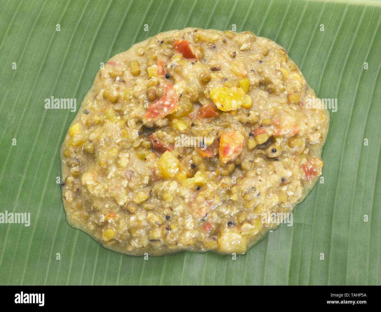 MOONG AND COCONUT KOOTUKARI SERVED IN A TRADITIONAL TAMIL LUNCH ON A GREEN PLANTAIN LEAF Stock Photo