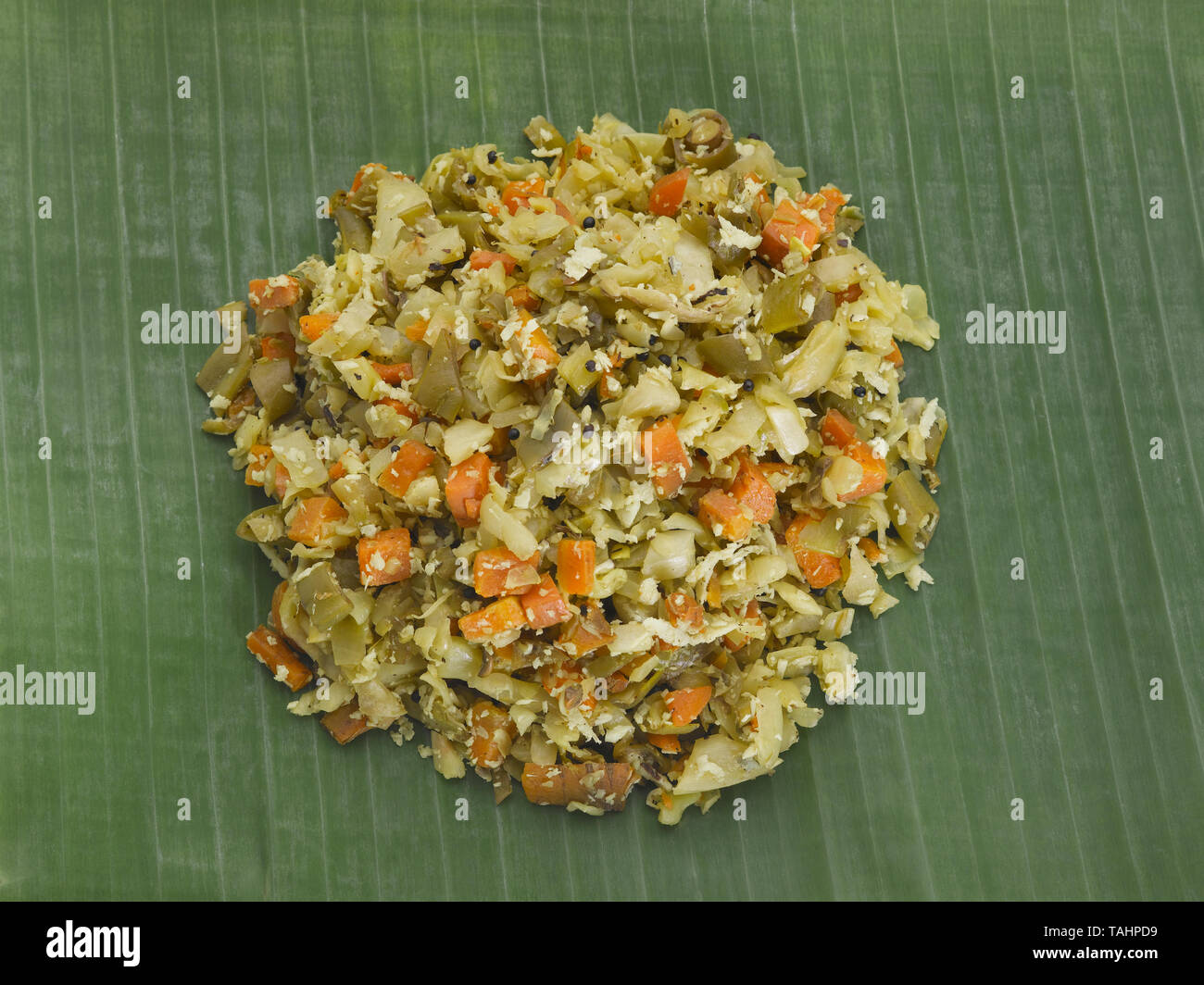 PORIYAL- A VEGETABLE SERVED IN A  TRADITIONAL TAMIL LUNCH ON A GREEN PLANTAIN LEAF Stock Photo