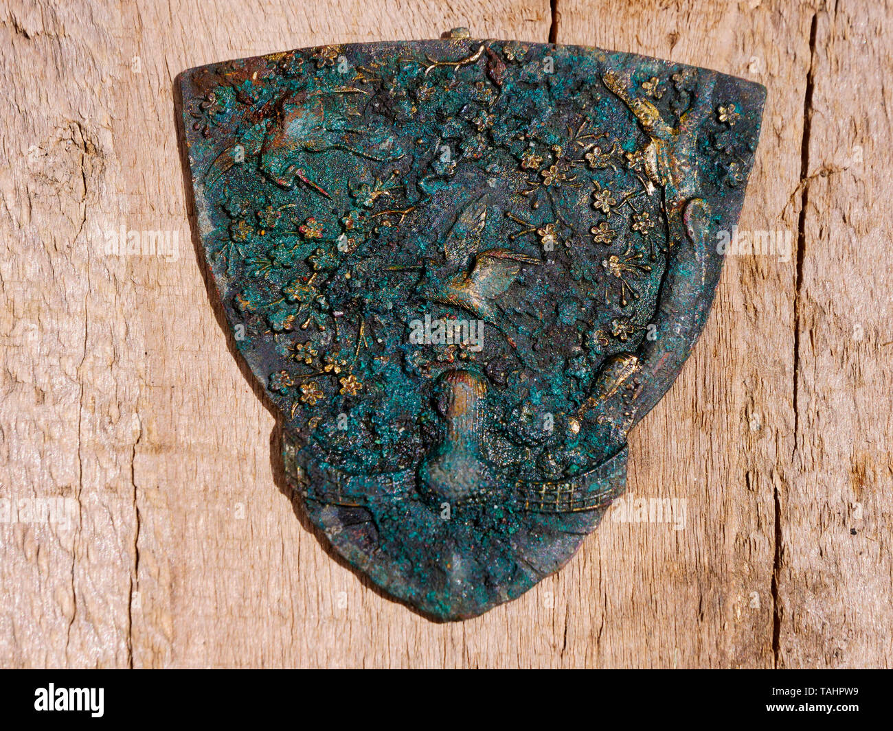 metal detector find bronze brass gold plate crane birds tree flowers by Doug Blane in Wirksworth, Derbyshire Dales, Peak District, England, UK Stock Photo