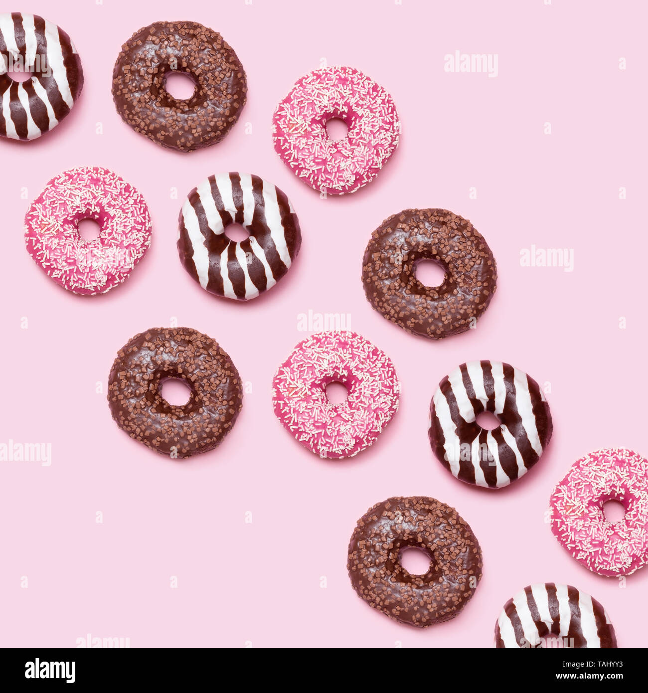 Colorful donuts pattern on pink background Stock Photo