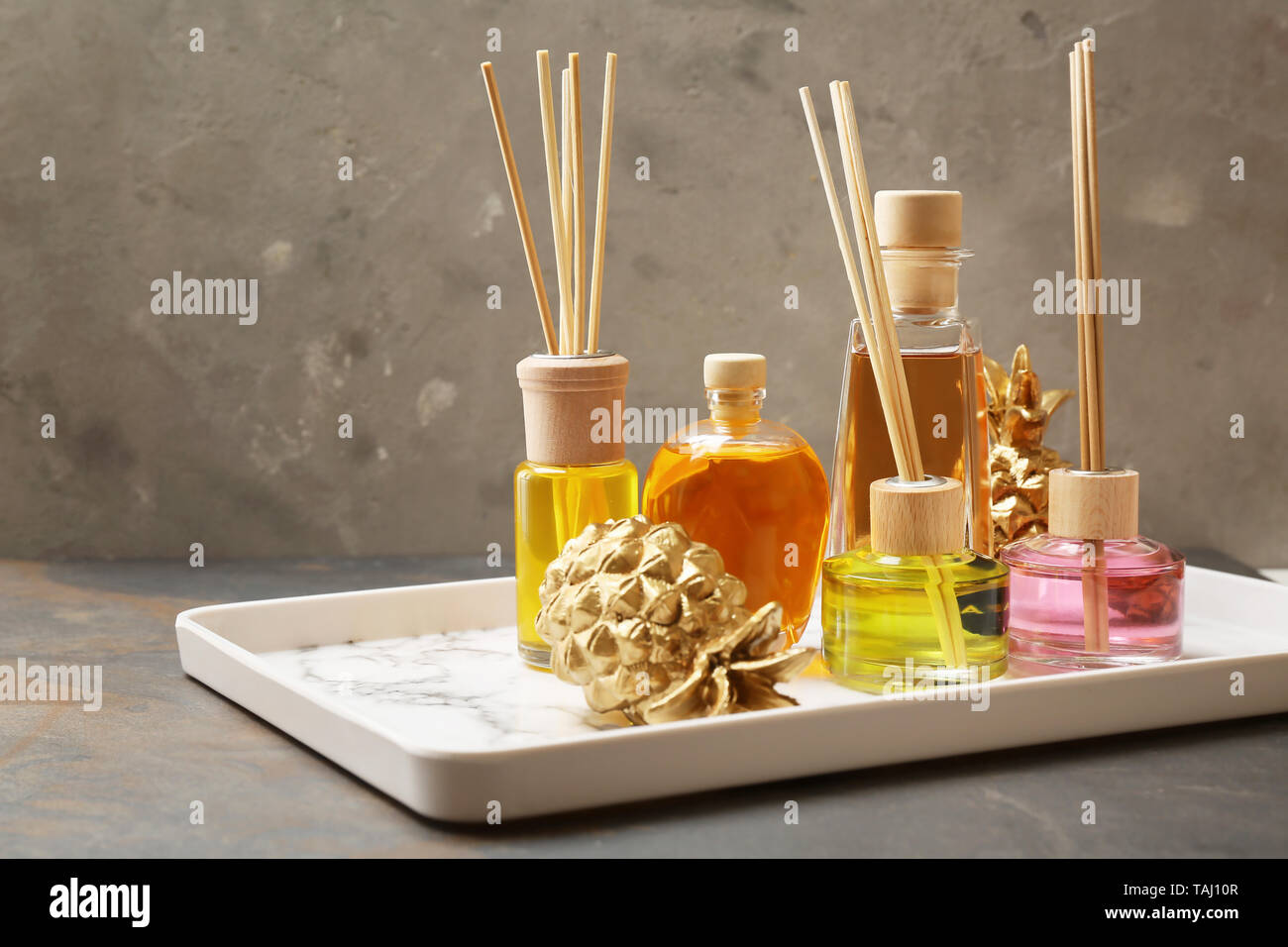 Tray with different reed diffusers on table Stock Photo