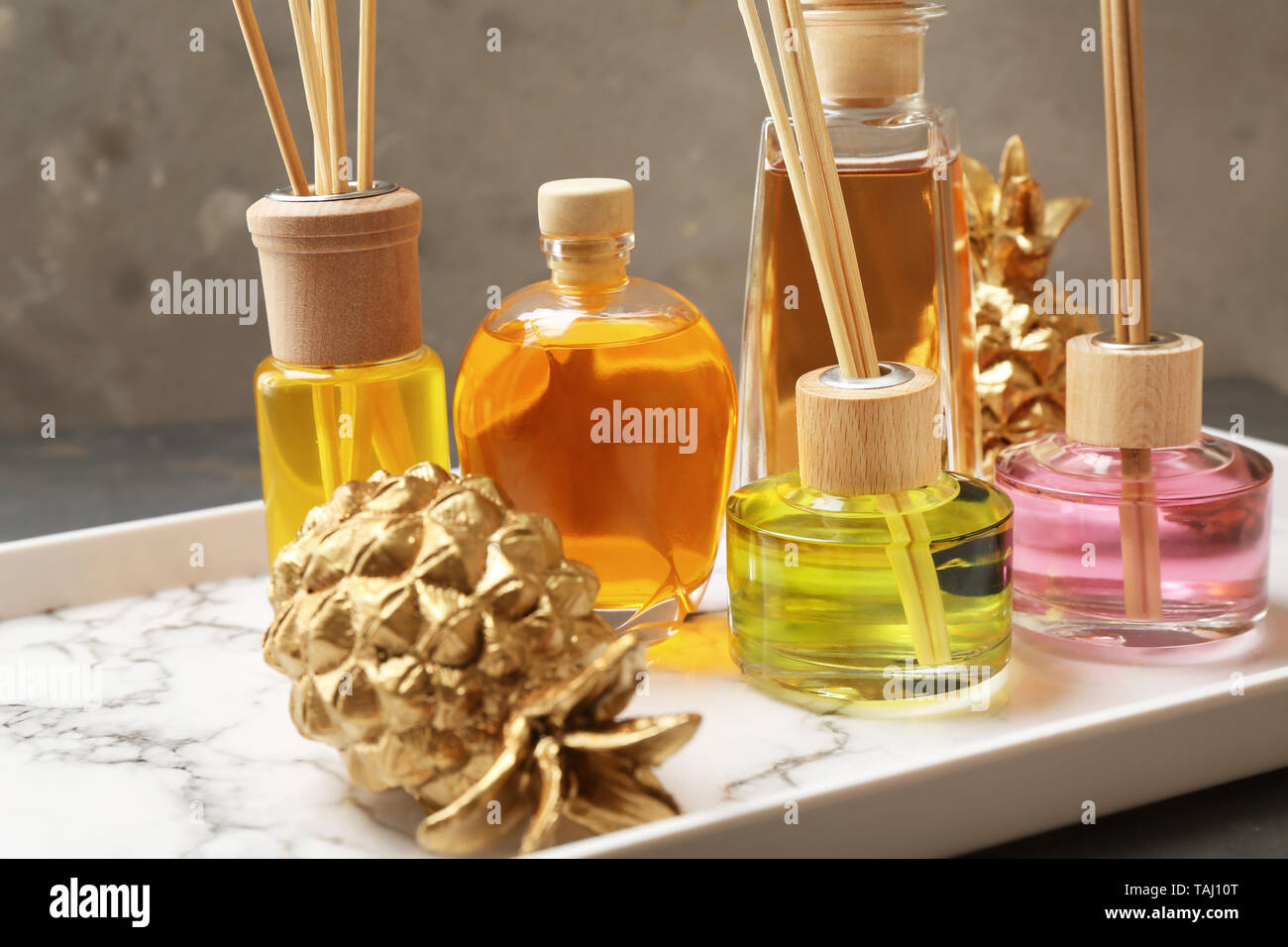 Tray with different reed diffusers on table Stock Photo
