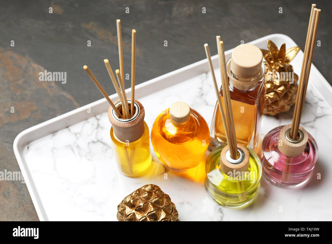 Tray with different reed diffusers on table Stock Photo