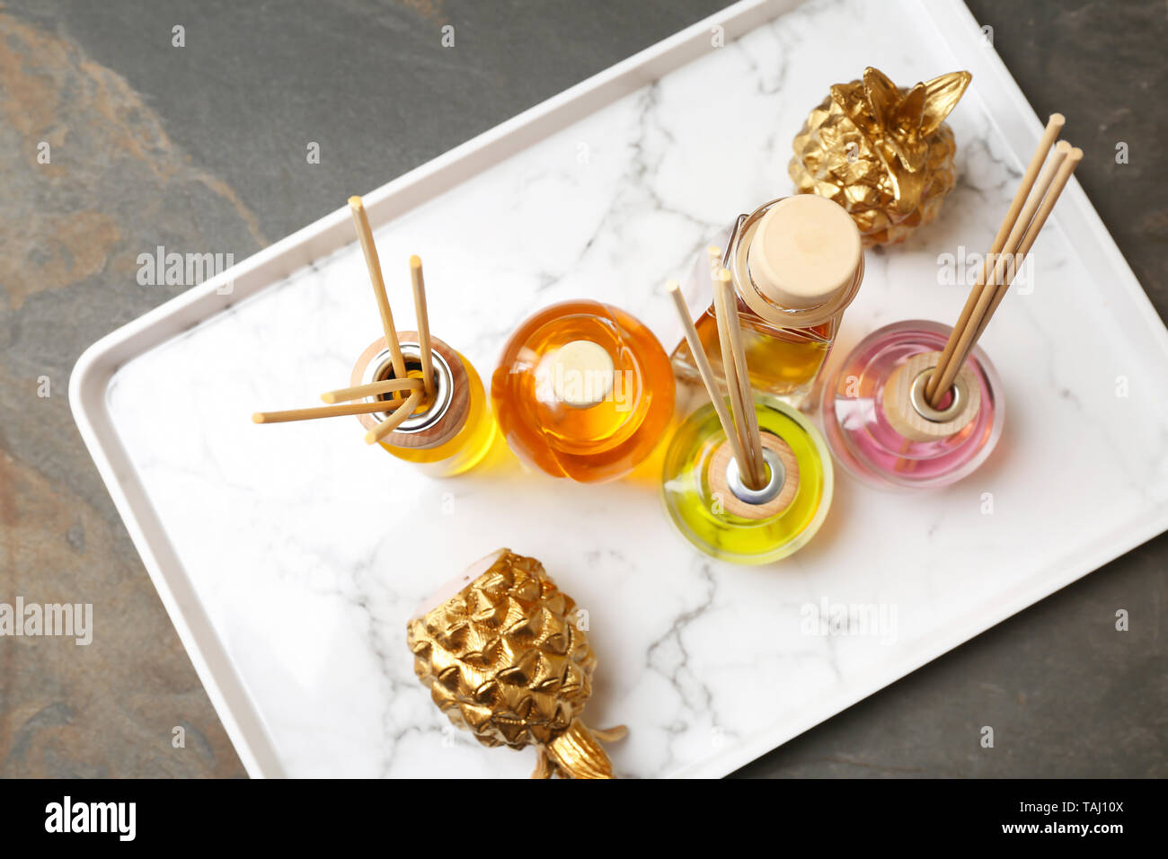 Tray with different reed diffusers on table Stock Photo