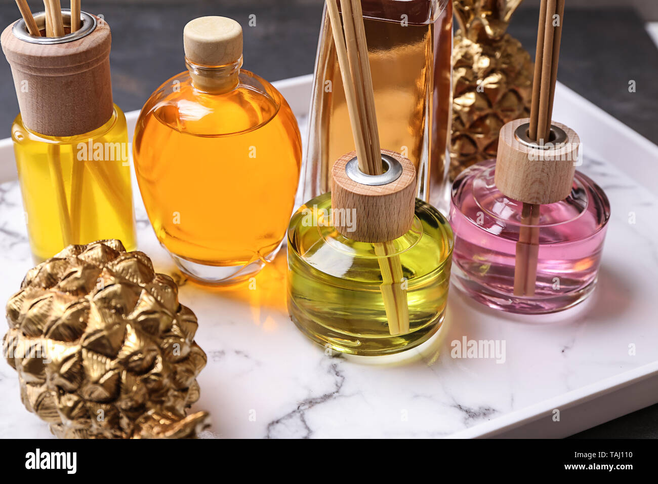 Tray with different reed diffusers on table Stock Photo
