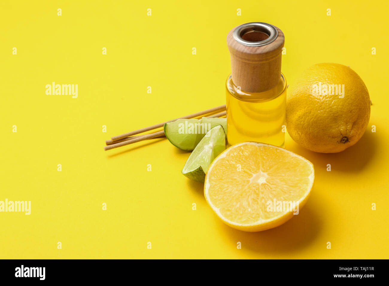 Citrus reed diffuser on color background Stock Photo