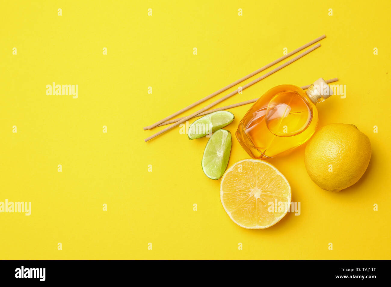 Citrus reed diffuser on color background Stock Photo