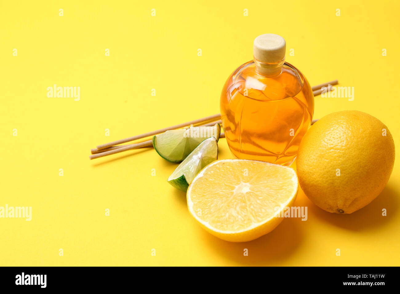Citrus reed diffuser on color background Stock Photo