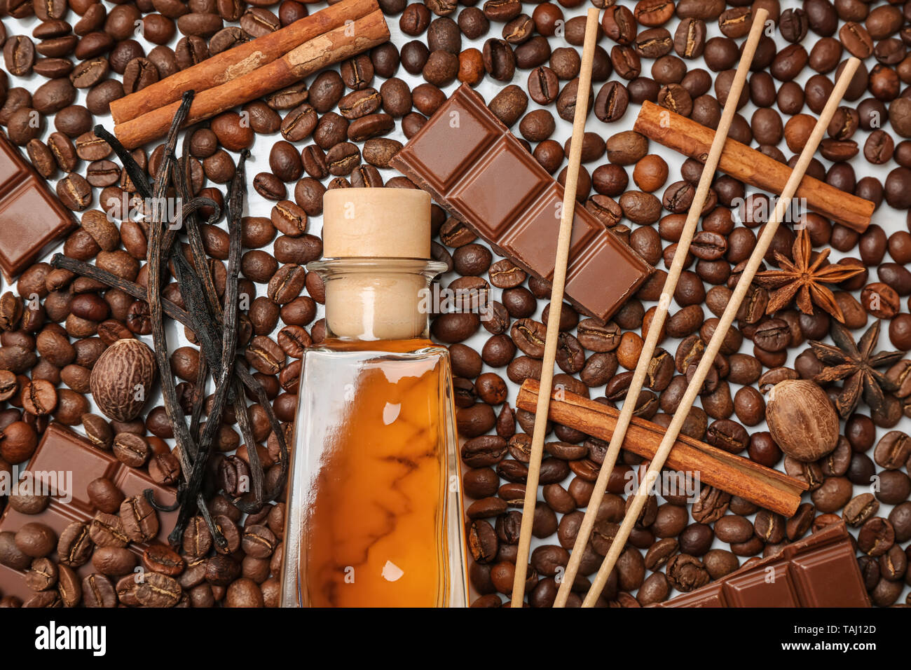 Reed diffuser, chocolate and cinnamon on coffee beans Stock Photo