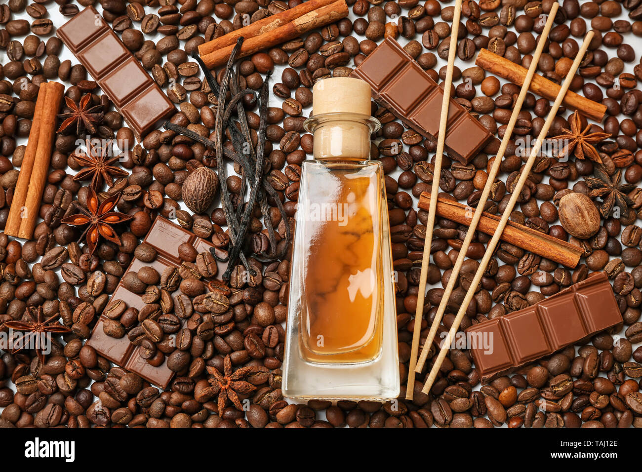 Reed diffuser, chocolate and cinnamon on coffee beans Stock Photo