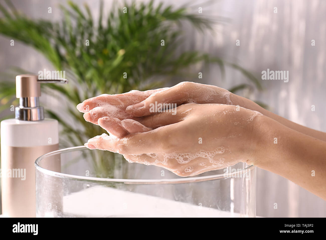 Woman washing hands with soap in bathroom Stock Photo - Alamy