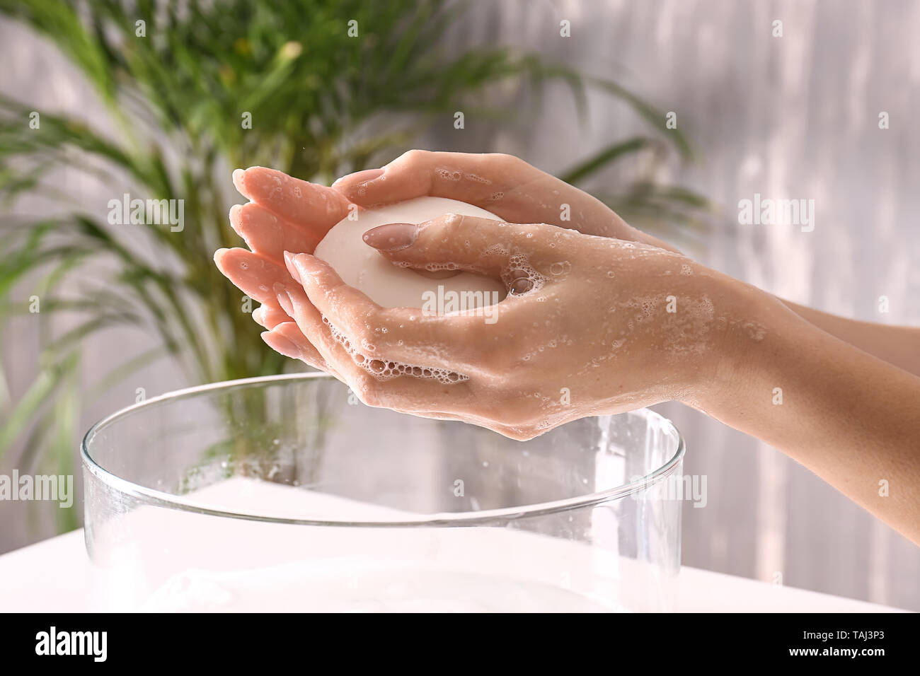 Woman washing hands with soap in bathroom Stock Photo - Alamy