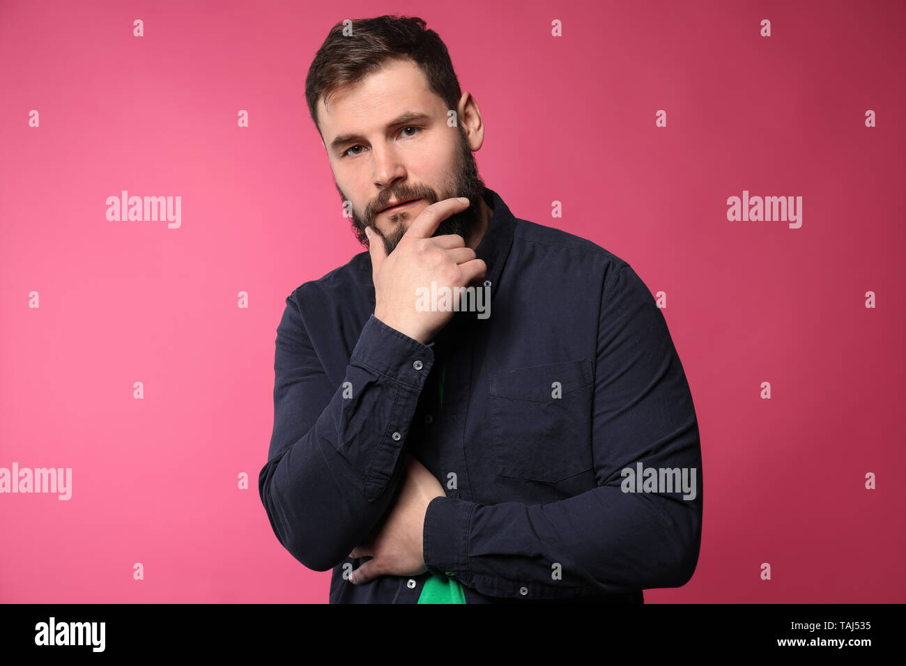 Bearded man in casual clothes on color background Stock Photo - Alamy
