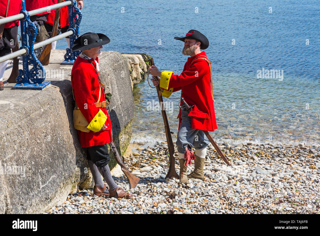 Swanage, Dorset, UK. 25th May 2019. Pirates arrive in Swanage for the Purbeck Pirate Festival on a warm sunny day.  Skirmish on Monkey Beach - reenactment battle of Redcoats against pirates. Credit: Carolyn Jenkins/Alamy Live News Stock Photo