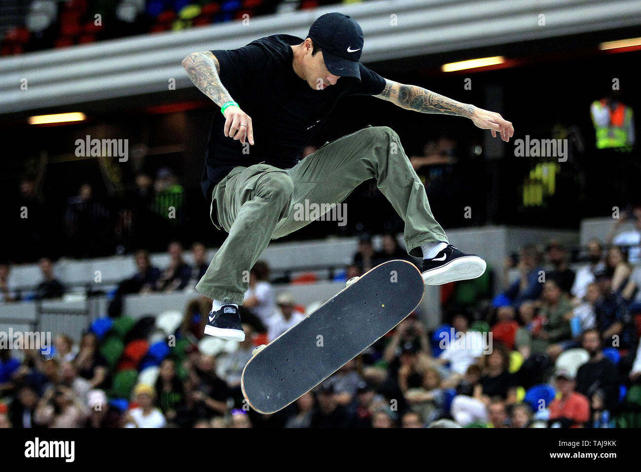 A male skater pulls a kick flip trick during the men's quarter finals. 2019  SLS World Tour, Street League Skateboarding event at the Copper Box arena,  Queen Elizabeth Olympic Park in London