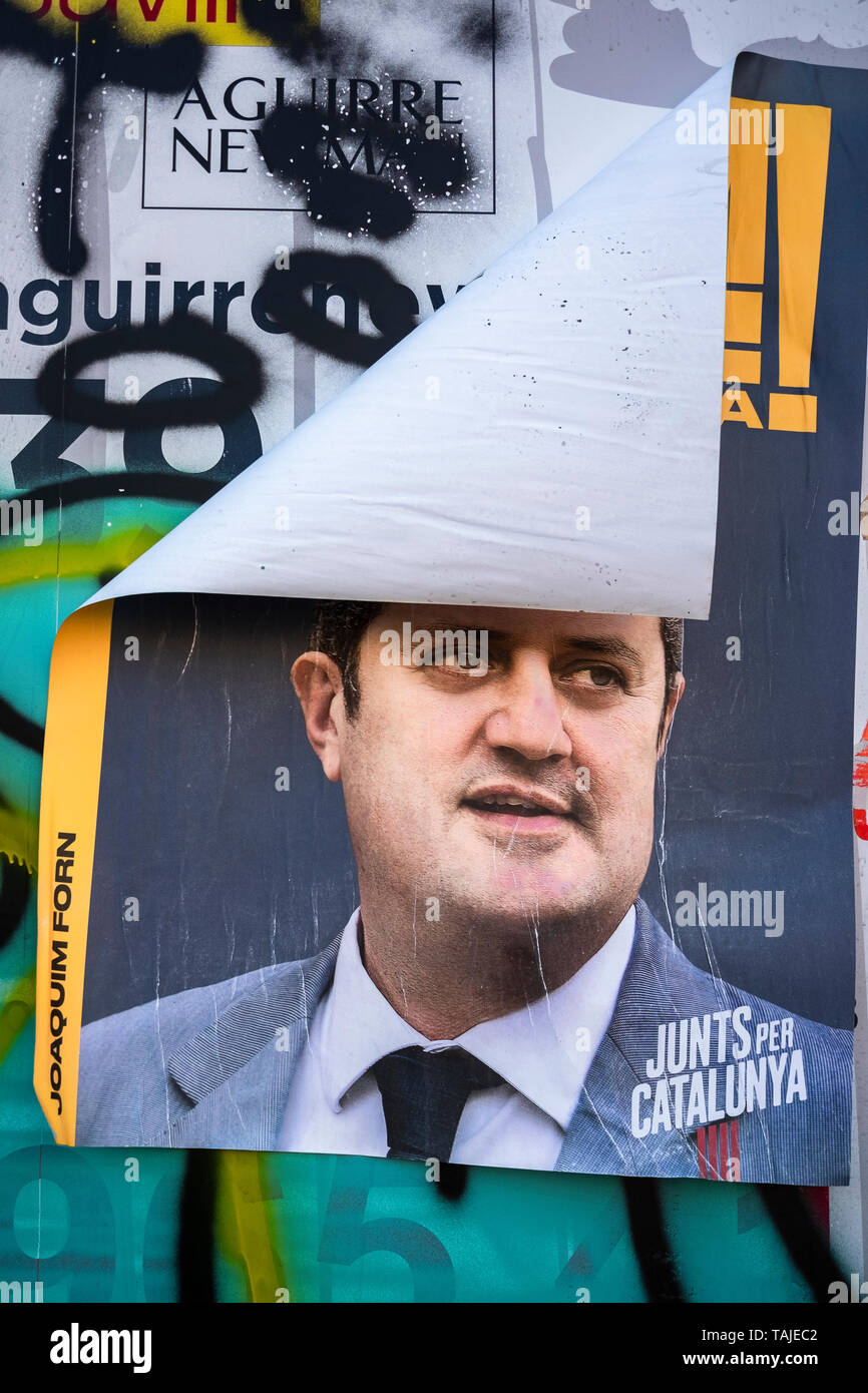 The electoral propaganda poster of the independence candidate currently in prison Joaquim Forn is seen hanging half off the wall. Election posters are seen broken, manipulated or covered by other posters during the last week of the election campaign. Stock Photo