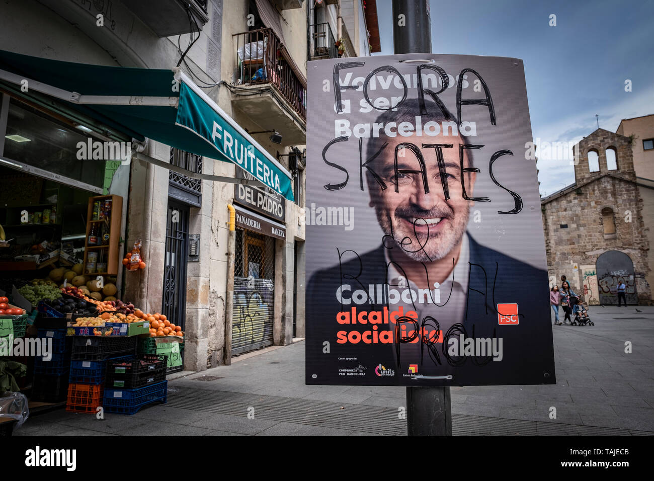 The poster of electoral propaganda of the socialist Jaume Collboni is defaced with a message asking for the expulsion of the Skaters from the Raval neighbourhood. Election posters are seen broken, manipulated or covered by other posters during the last week of the election campaign. Stock Photo