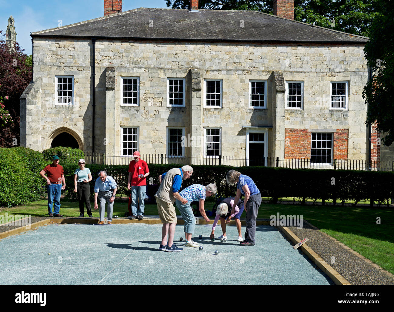 Playing boules in front of the Bishop's Palace, Howden, East Yorkshire, England UK Stock Photo