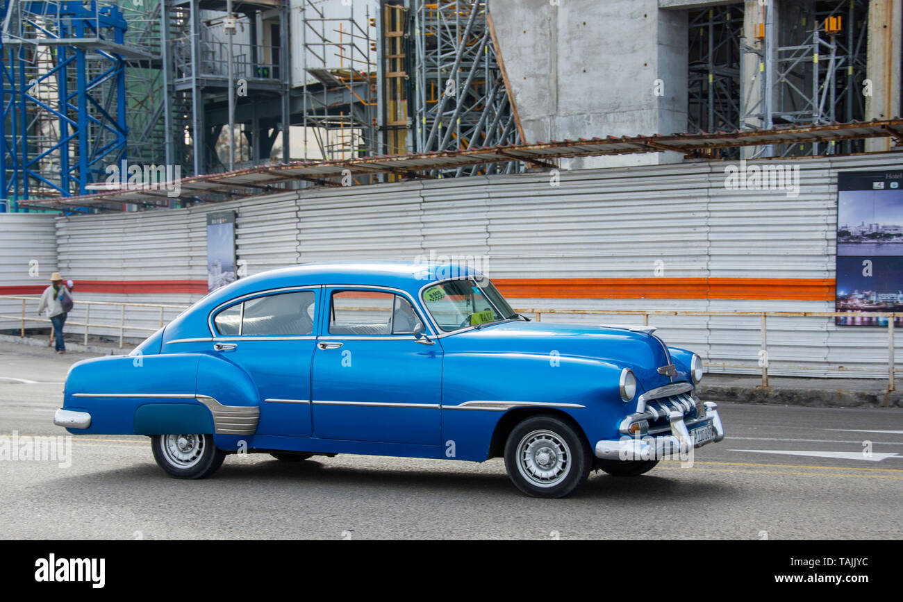 Havana, Cuba - A taxi on the Malecón road facing Havana Bay. Classic American cars from the 1950s, imported before the U.S. embargo, are commonly used Stock Photo