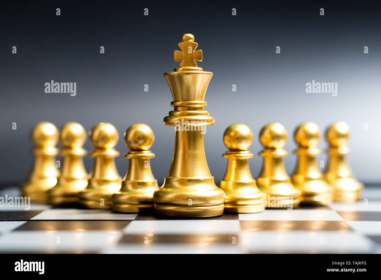 Gold king chess piece stand in front of pawn on black background (Concept  of leadership, management Stock Photo - Alamy
