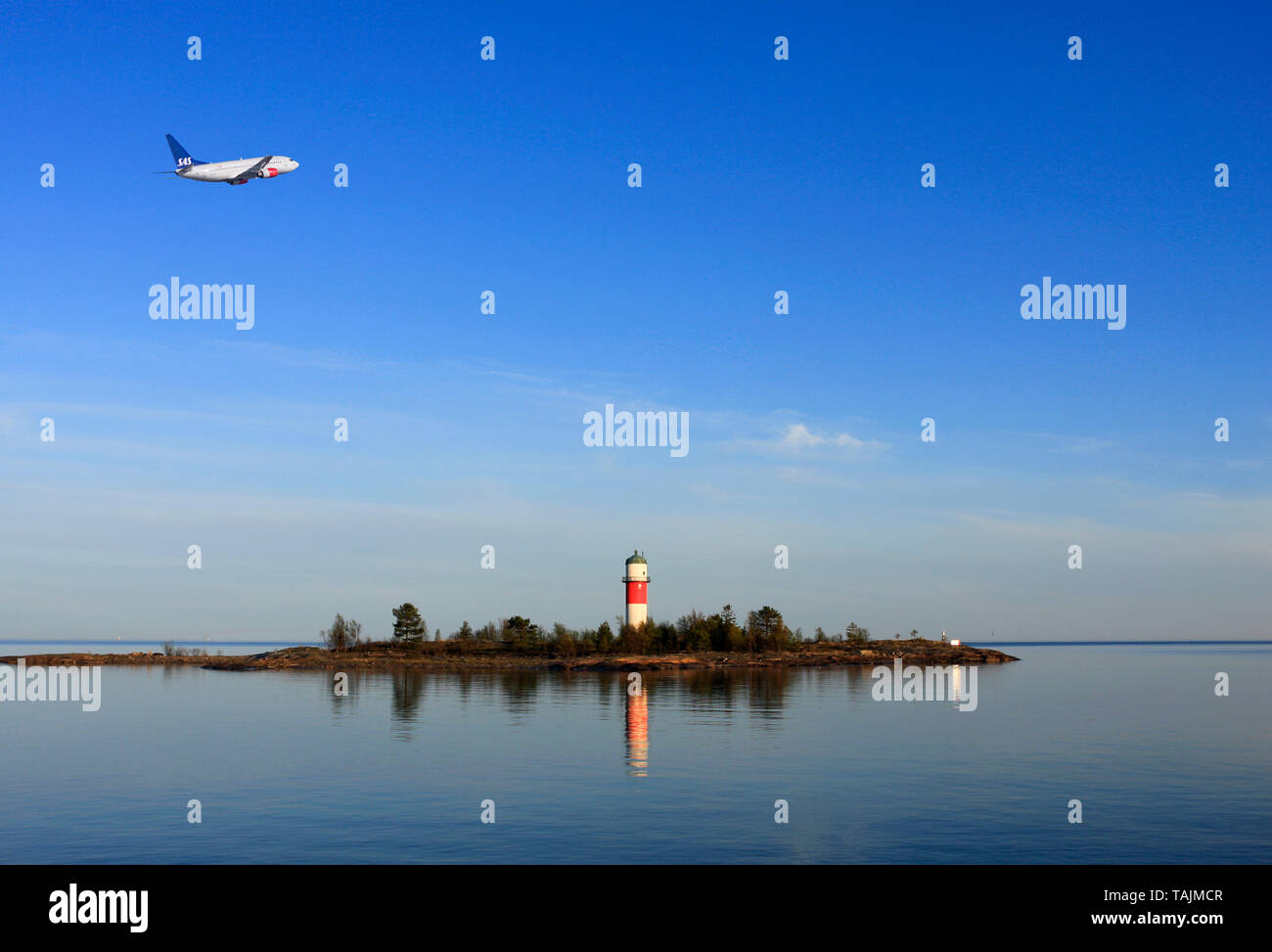 HOLMSUND, SWEDEN ON MAY 21, 2010. View of a SAS Jet-liner above the inlet.  Beacon and bright sunny evening. Editorial use. Stock Photo