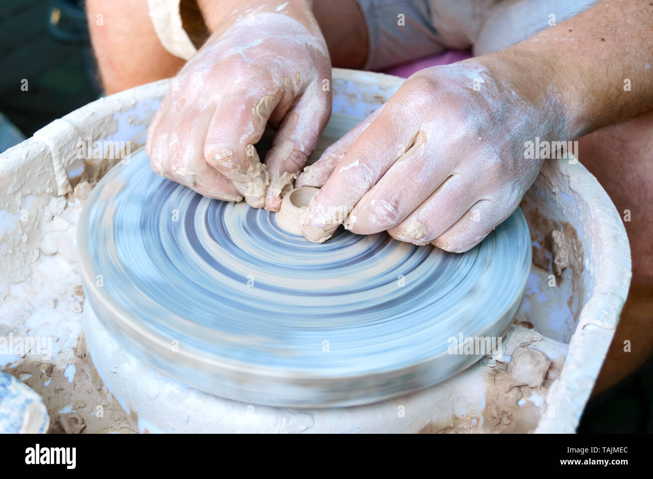 Making pottery on a potter's wheel. Hands craftsman close-up, mold dishes. Master class Stock Photo