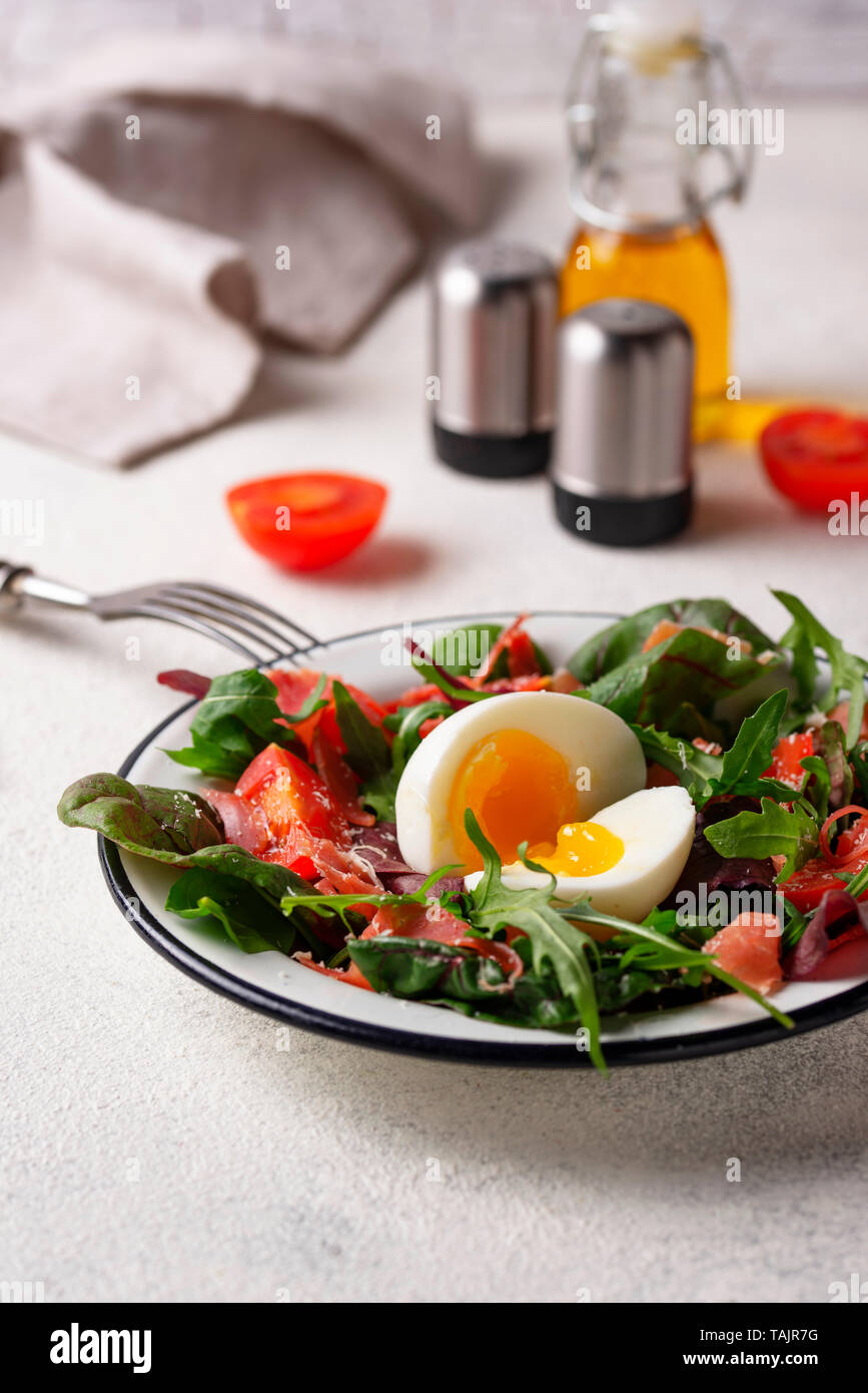Healthy salad with prosciutto, tomato and egg Stock Photo Alamy